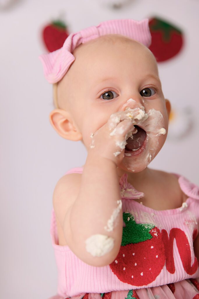 Strawberry and Daisy's on a white backdrop for a berry first birthday cake smash by Melbourne cake smash photographer Aurora Joy Photography