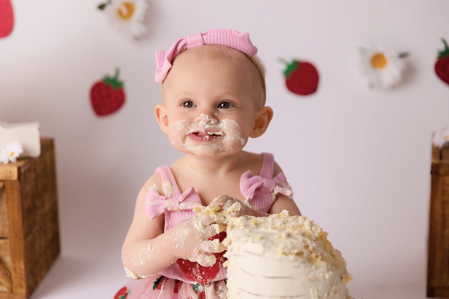 Strawberry and Daisy's on a white backdrop for a berry first birthday cake smash by Melbourne cake smash photographer Aurora Joy Photography