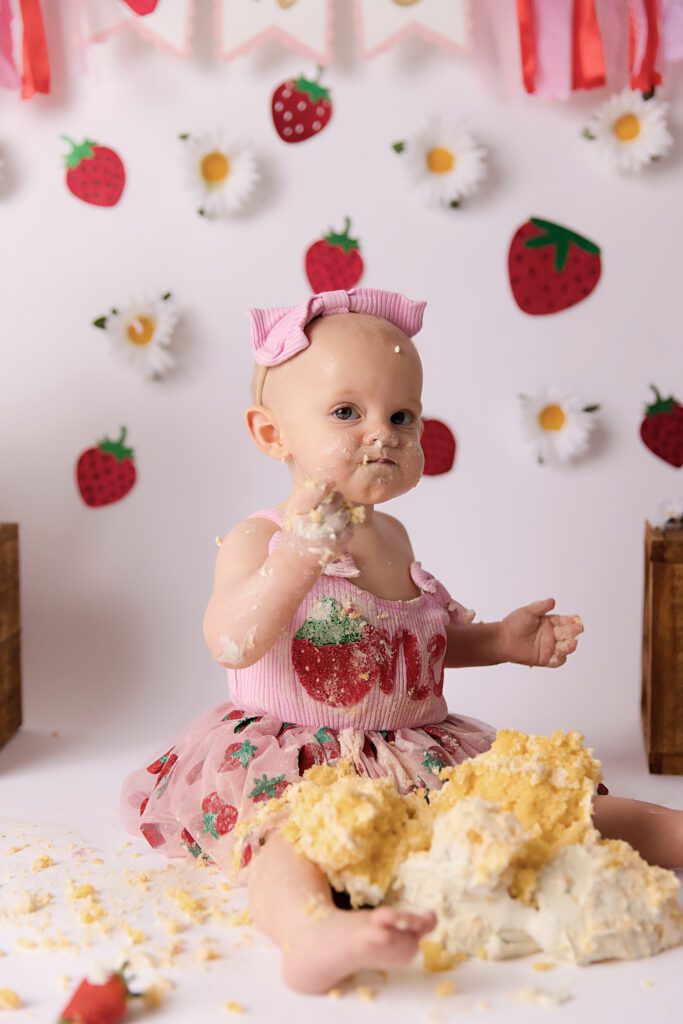 Strawberry and Daisy's on a white backdrop for a berry first birthday cake smash by Melbourne cake smash photographer Aurora Joy Photography