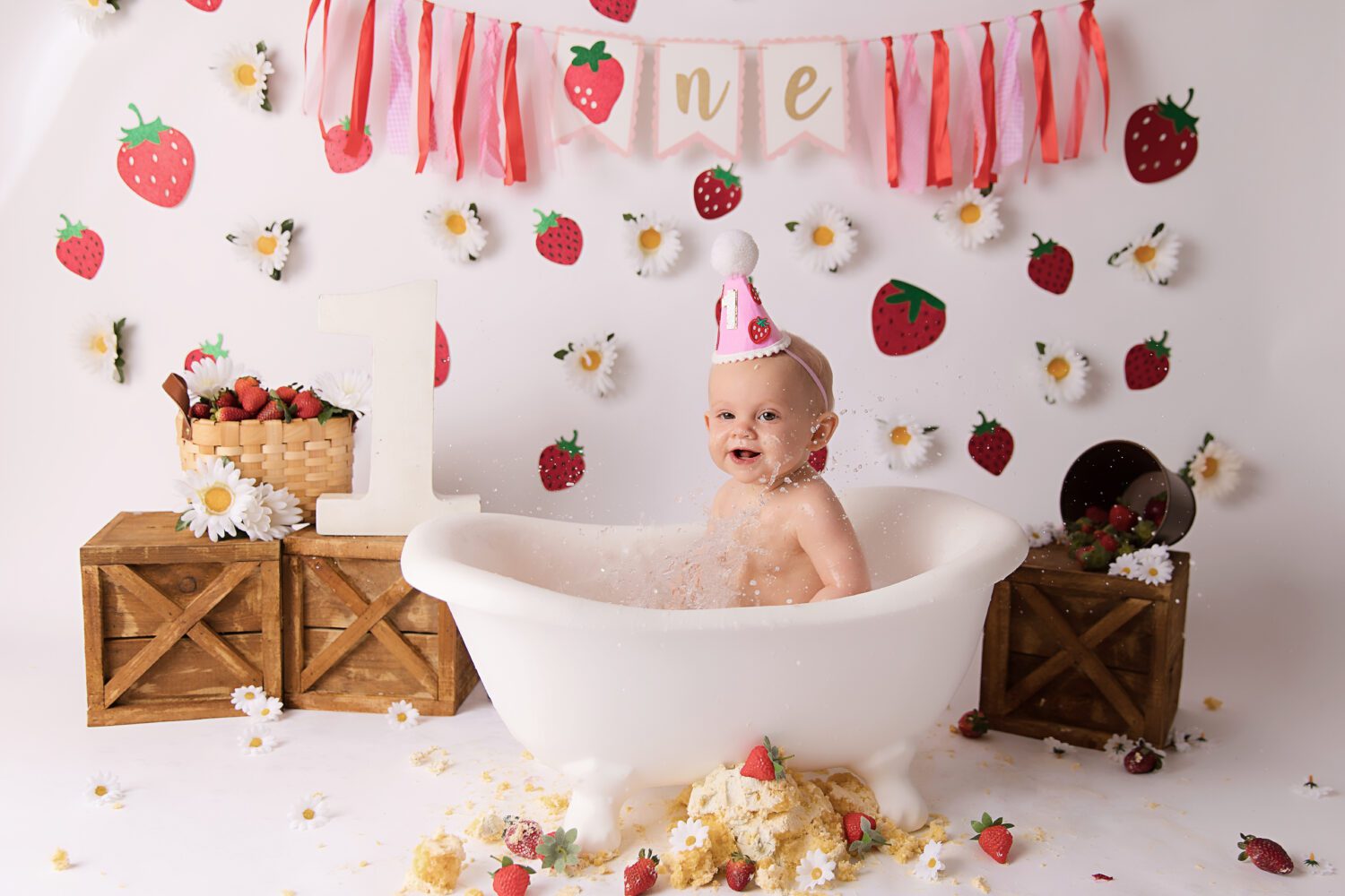 Strawberry and Daisy's on a white backdrop for a berry first birthday cake smash by Melbourne cake smash photographer Aurora Joy Photography