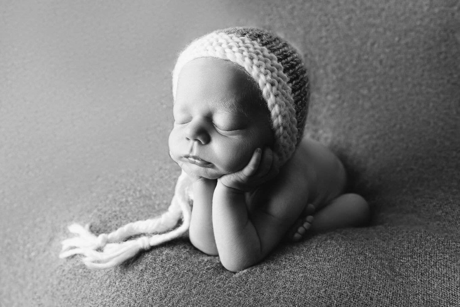 side profile Adorable newborn baby boy in a curled froggy pose on a soft grey studio backdrop — newborn photography by Aurora Joy Photography, Stirling Western Australia